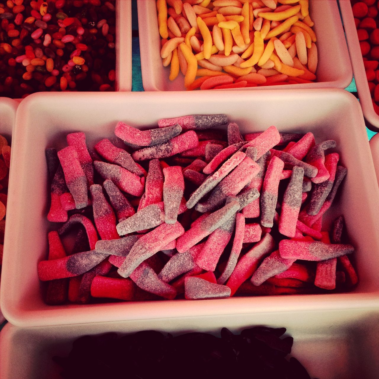 indoors, food and drink, food, freshness, still life, healthy eating, red, close-up, high angle view, ready-to-eat, for sale, retail, sweet food, indulgence, abundance, raw food, large group of objects, no people, table