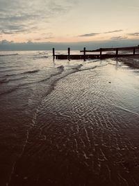 Scenic view of beach against sky during sunset