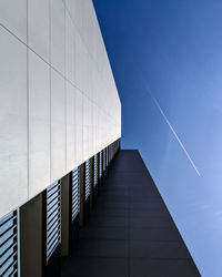 Low angle view of modern building against clear blue sky