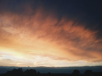 Scenic view of landscape against cloudy sky