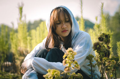 Beautiful woman sitting on field