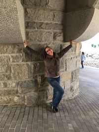 Full length of woman standing by railing