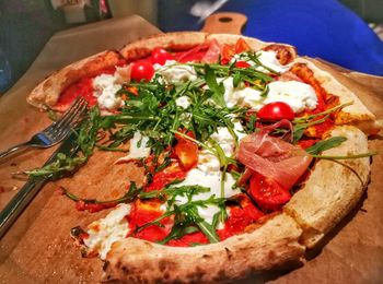 High angle view of pizza served on table