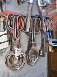 Close-up of rusty chain hanging on wall