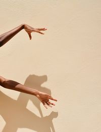 Shadow of woman hand on wall