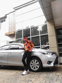 Man standing by car
