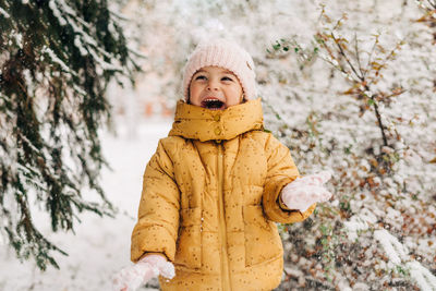 Portrait of boy standing in snow