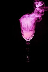 Close-up of wine glass against black background