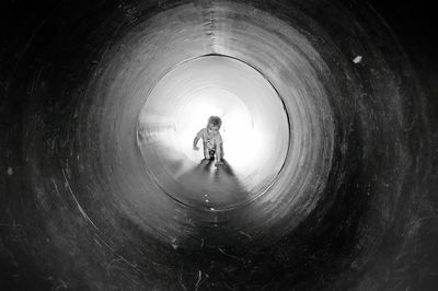 Toddler crawling in pipe