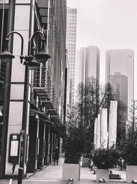 Street amidst buildings against sky in city