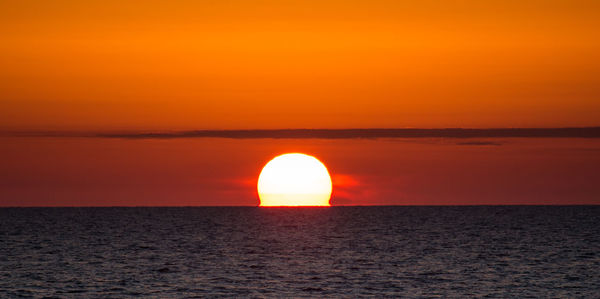 Scenic view of sea against romantic sky at sunset