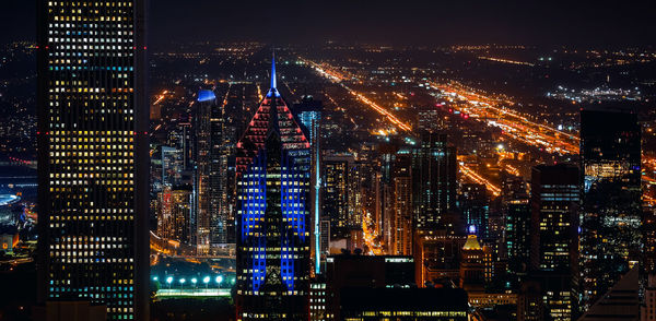 Illuminated buildings in city at night