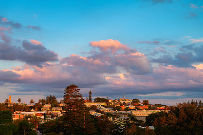 Townscape against sky during sunset