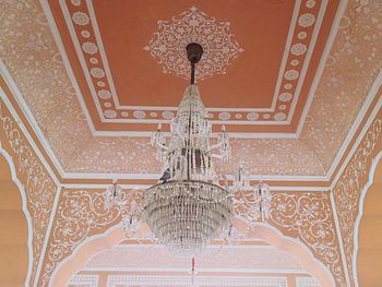 Low angle view of illuminated chandelier in building