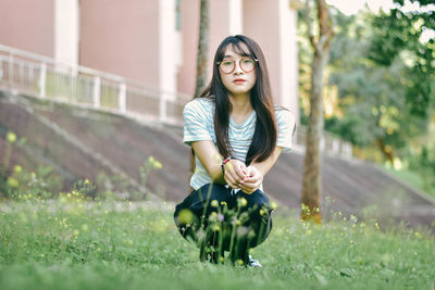 Portrait of young woman against plants