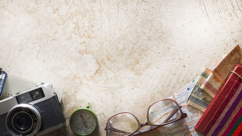 Directly above shot of technologies and travel equipment on table