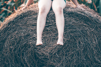 Low section of woman standing on field