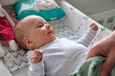 High angle view of baby boy lying on bed at home