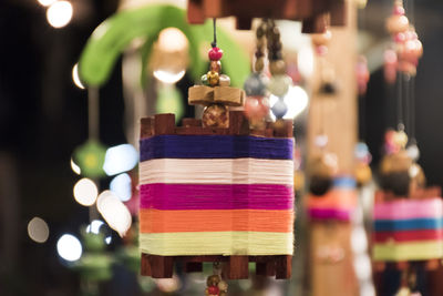 Close-up of decorations hanging in market for sale