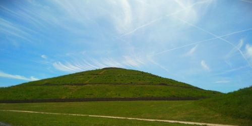 Scenic view of green landscape against sky