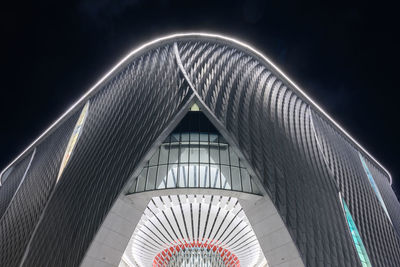 Low angle view of illuminated building against sky at night