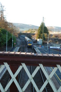 Railroad tracks by road against clear sky