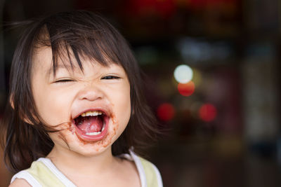 Portrait of happy cute cheerful baby girl with messy face