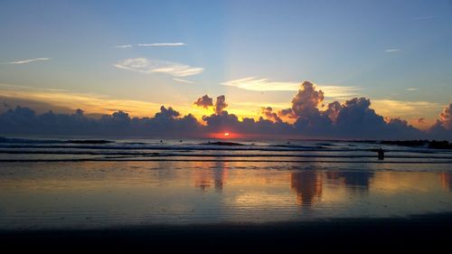 View of calm beach at sunset