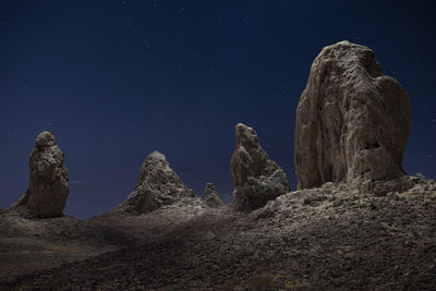 The pillars of trona illuminted from above on a starry night in