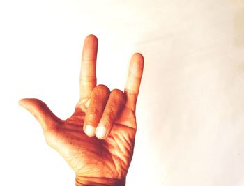 Close-up of human hand against white background