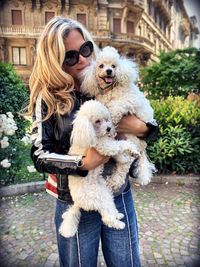 Woman carrying dogs in city