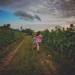 Rear view of girls running on field
