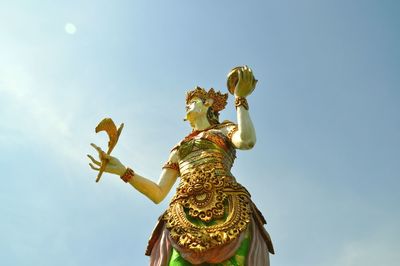 Low angle view of statue against blue sky