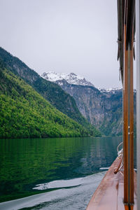 Scenic view of lake by mountains against sky