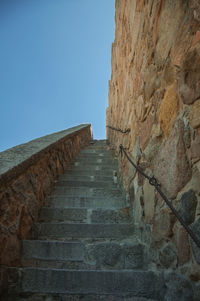 Low angle view of staircase against clear blue sky