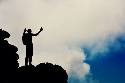 Low angle view of people against sky