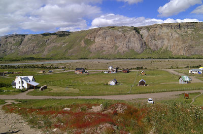 Scenic view of grassy field against sky