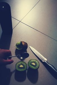 Low section of woman holding fruit on table