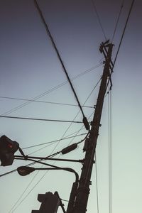 Low angle view of electricity pylon against sky