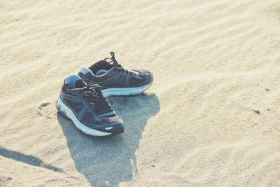 High angle view of shoes on beach