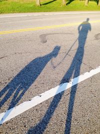 Shadow of people on road