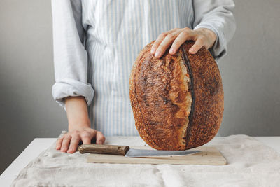 Midsection of man working on table