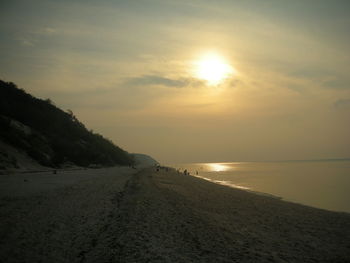 Scenic view of beach against sky during sunset