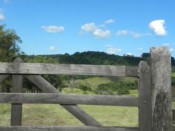 Fence on field against sky