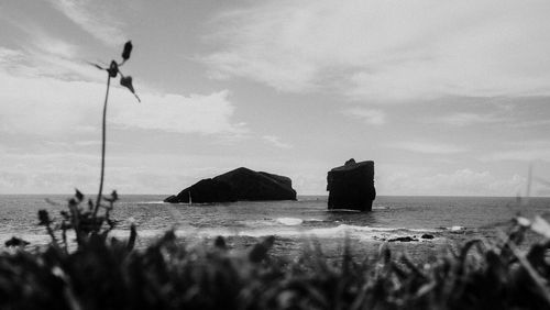 Panoramic view of rocks on beach against sky