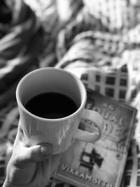 Close-up of hand holding coffee cup