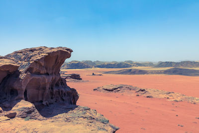 Rock formations in desert against blue sky