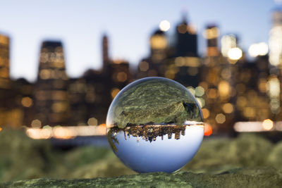 Close-up of crystal ball in city