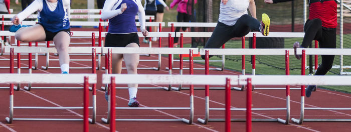 Midsection of women running on track