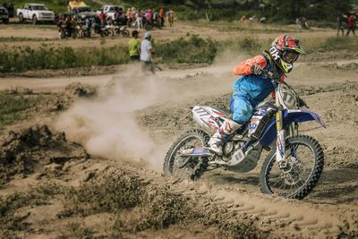 People riding motorcycle on field